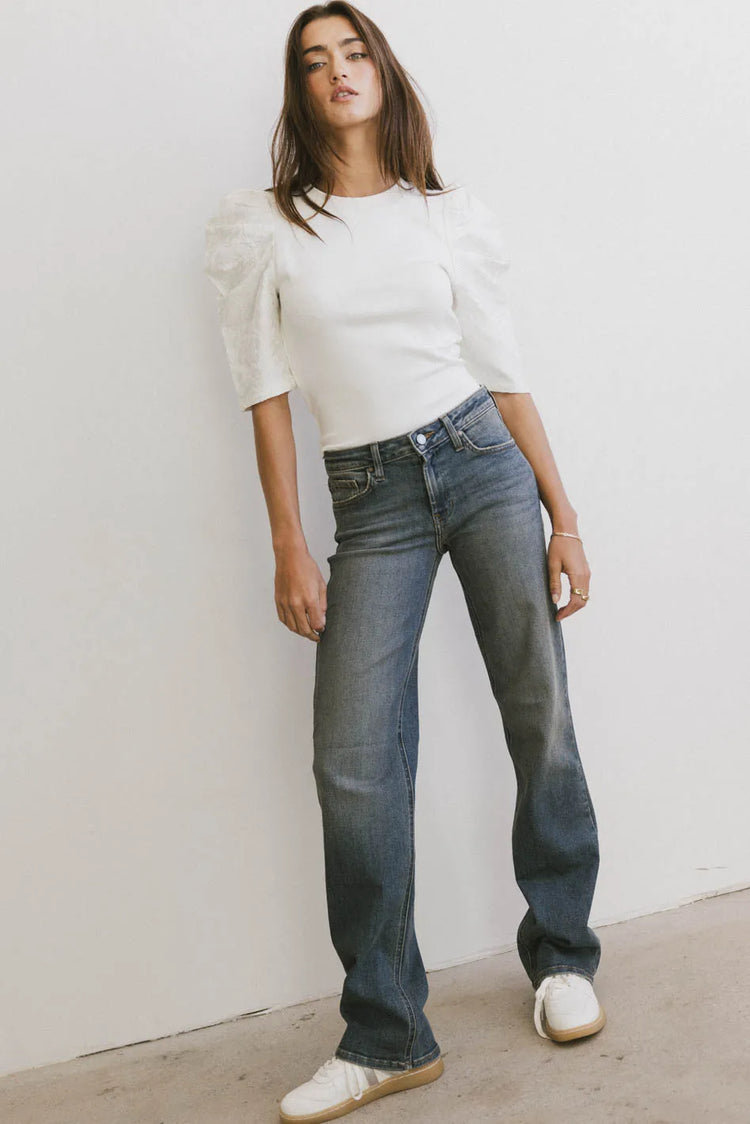 Denim pants paired with a white top
