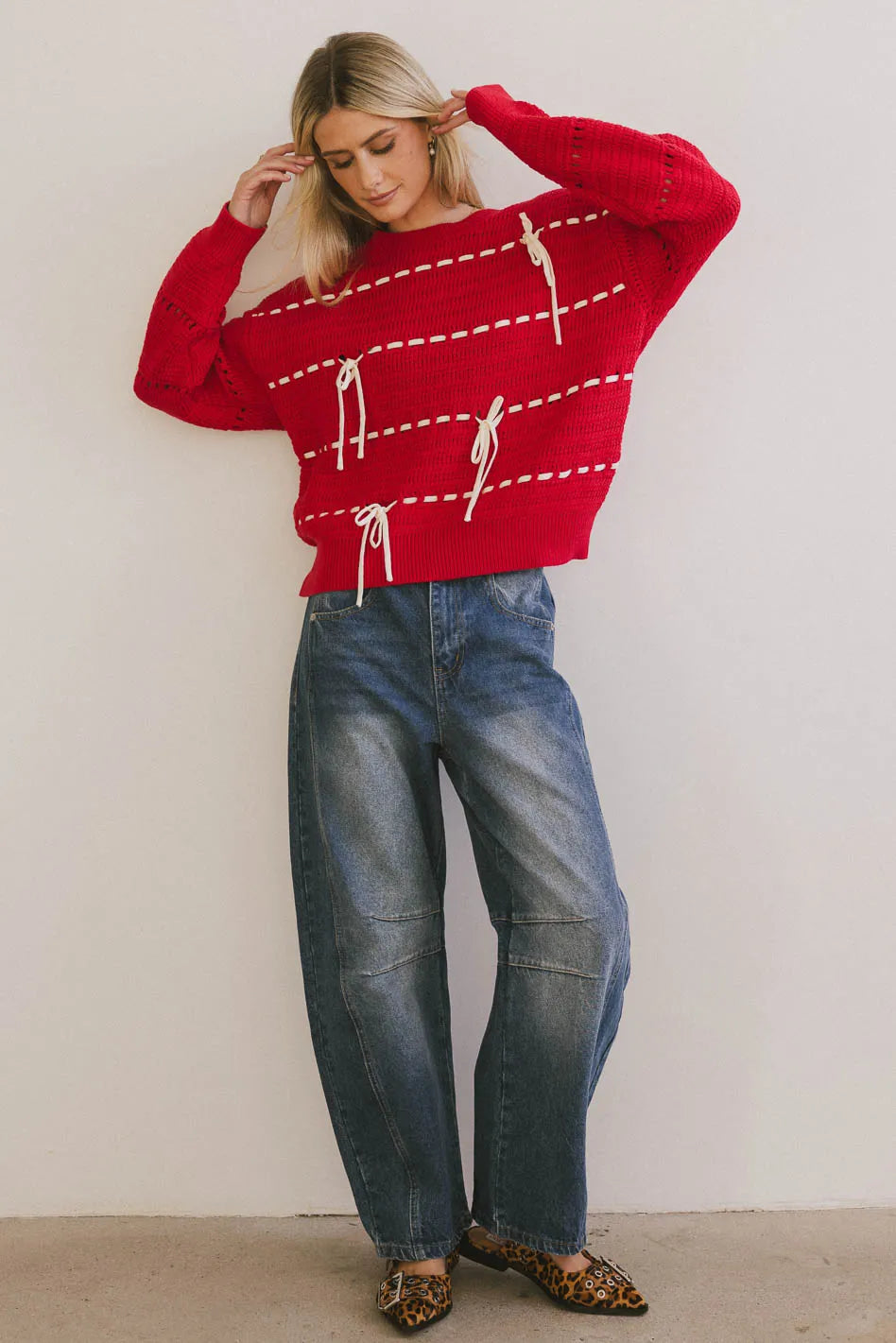 Sweater in red paired with denim