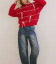 Sweater in red paired with denim