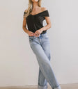 Top in black paired with a light wash denim