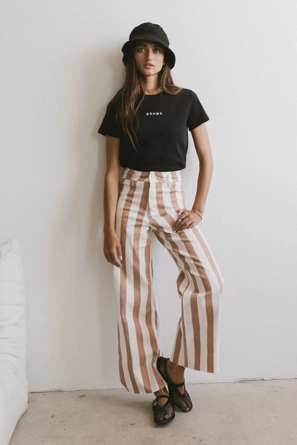 Top in black paired with a striped pants