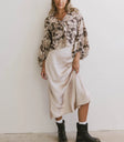 Top paired with a skirt in beige