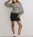 Top in black paired with a black skirt