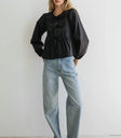 Blouse paired with light wash denim