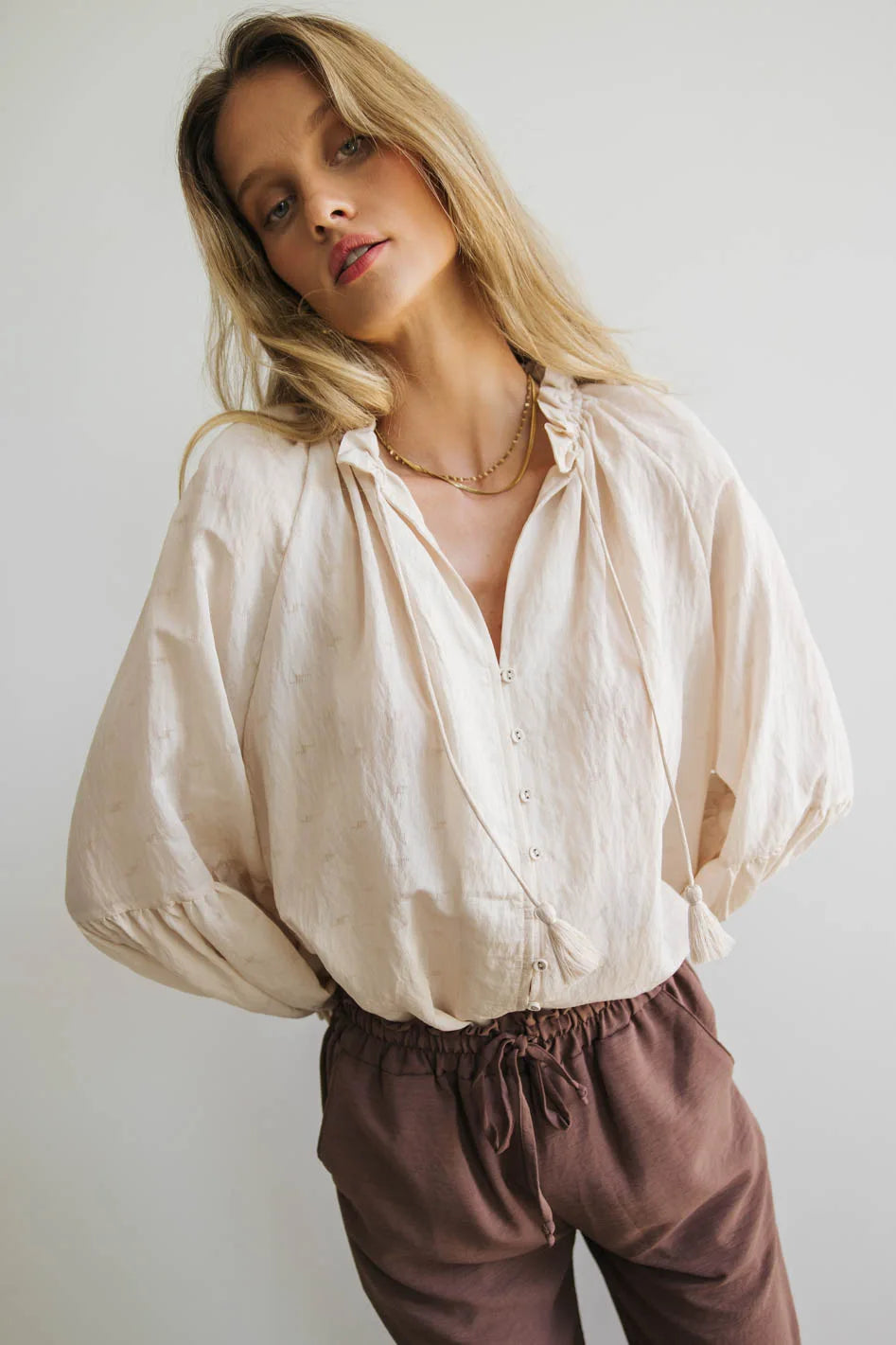 Ruffled round neck blouse in cream