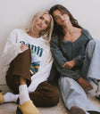 graphic sweater in white with brown denim
