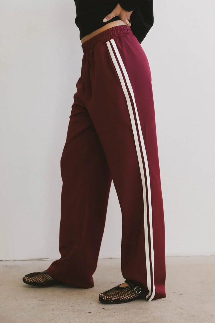 Two white straps on the side pants in burgundy