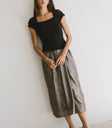 Midi skirt in gold pared with a black top