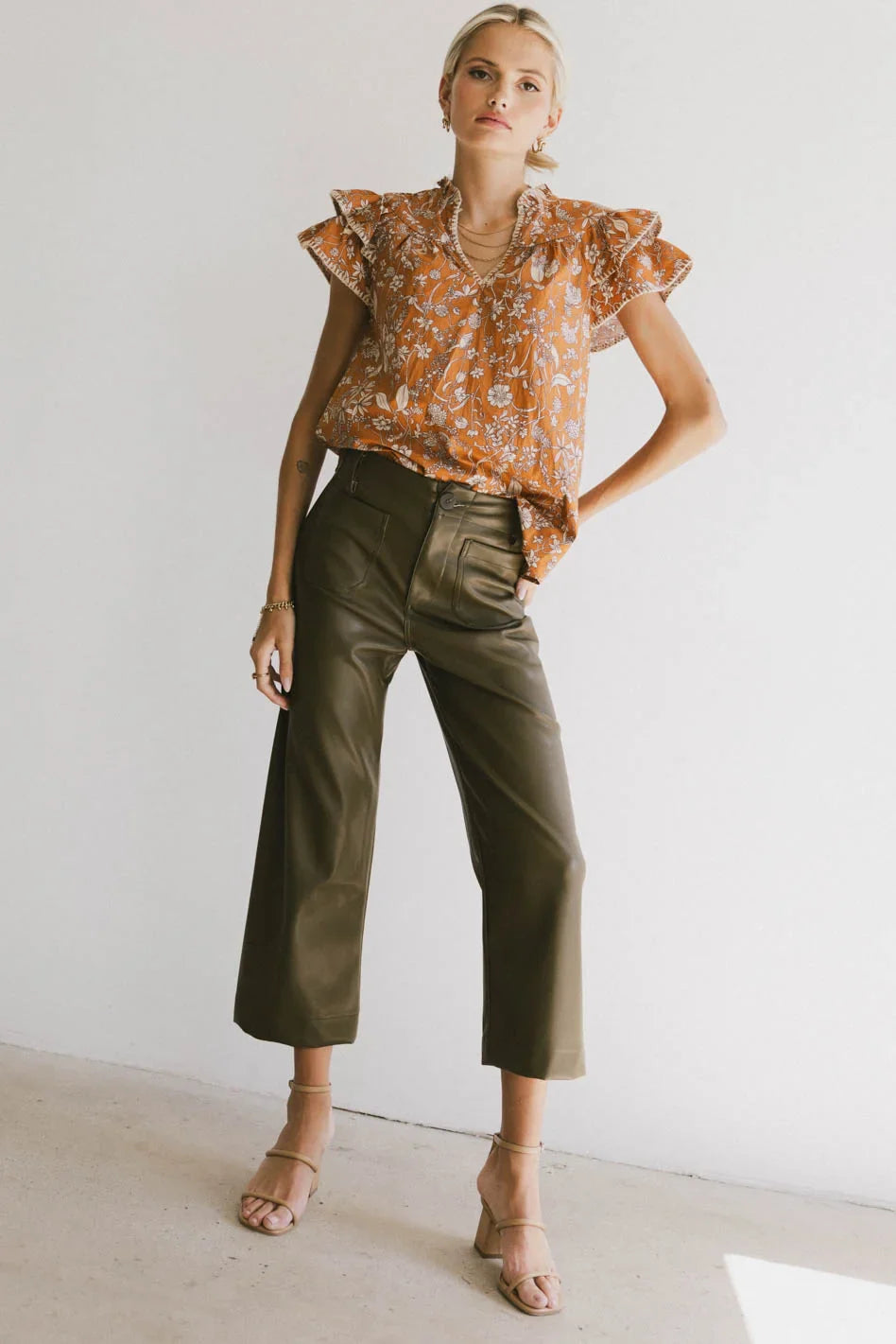 Top paired with a leather pants in olive