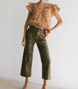 Top paired with a leather pants in olive