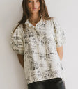 Ruffled round neck in cream