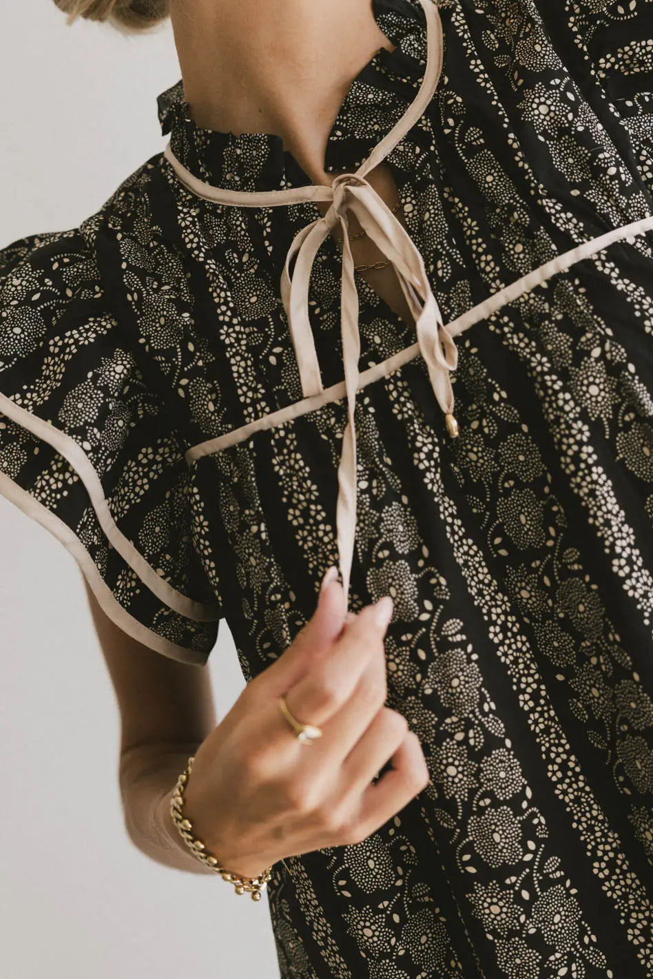 Ruffled round neck top in black