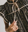 Ruffled round neck top in black