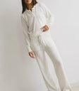 Pants paired with a cream sweater