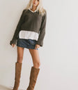 Sweater in olive paired with a denim mini skirt