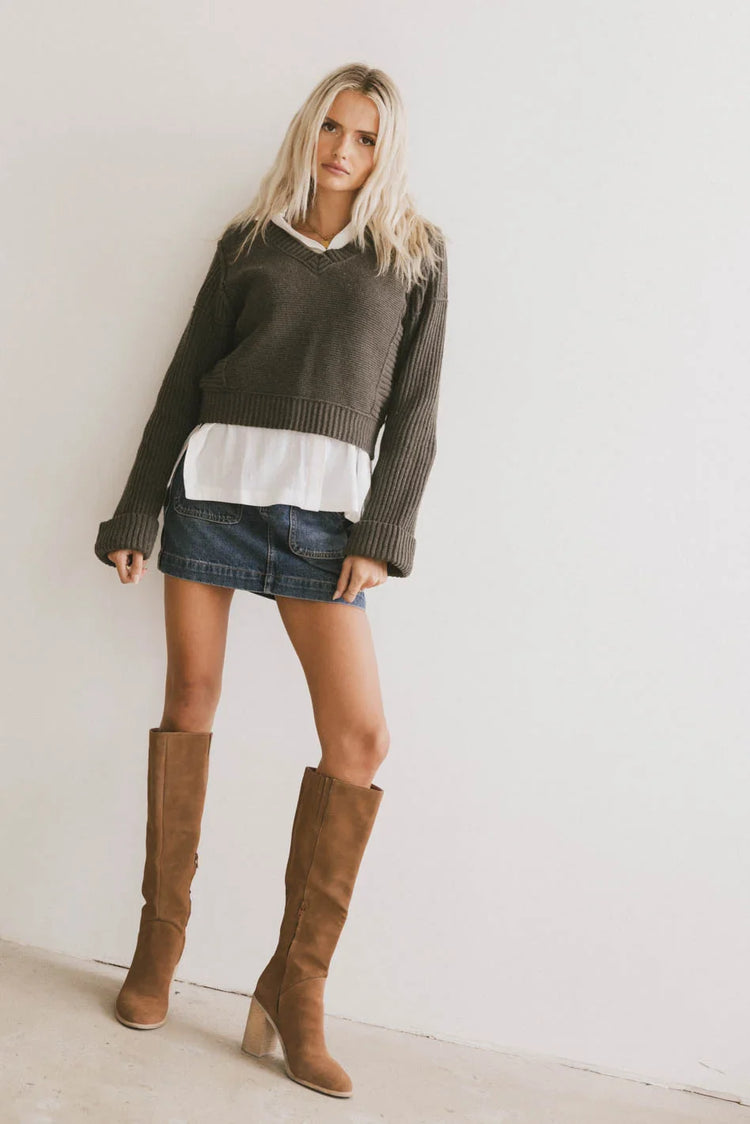 Sweater in olive paired with a denim mini skirt