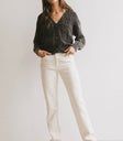 Cardigan in black paired with a cream pants