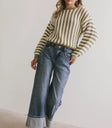 Striped sweater paired with medium wash denim