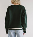 stripped trim on green sweater