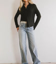 Button up top in black paired with light denim jeans