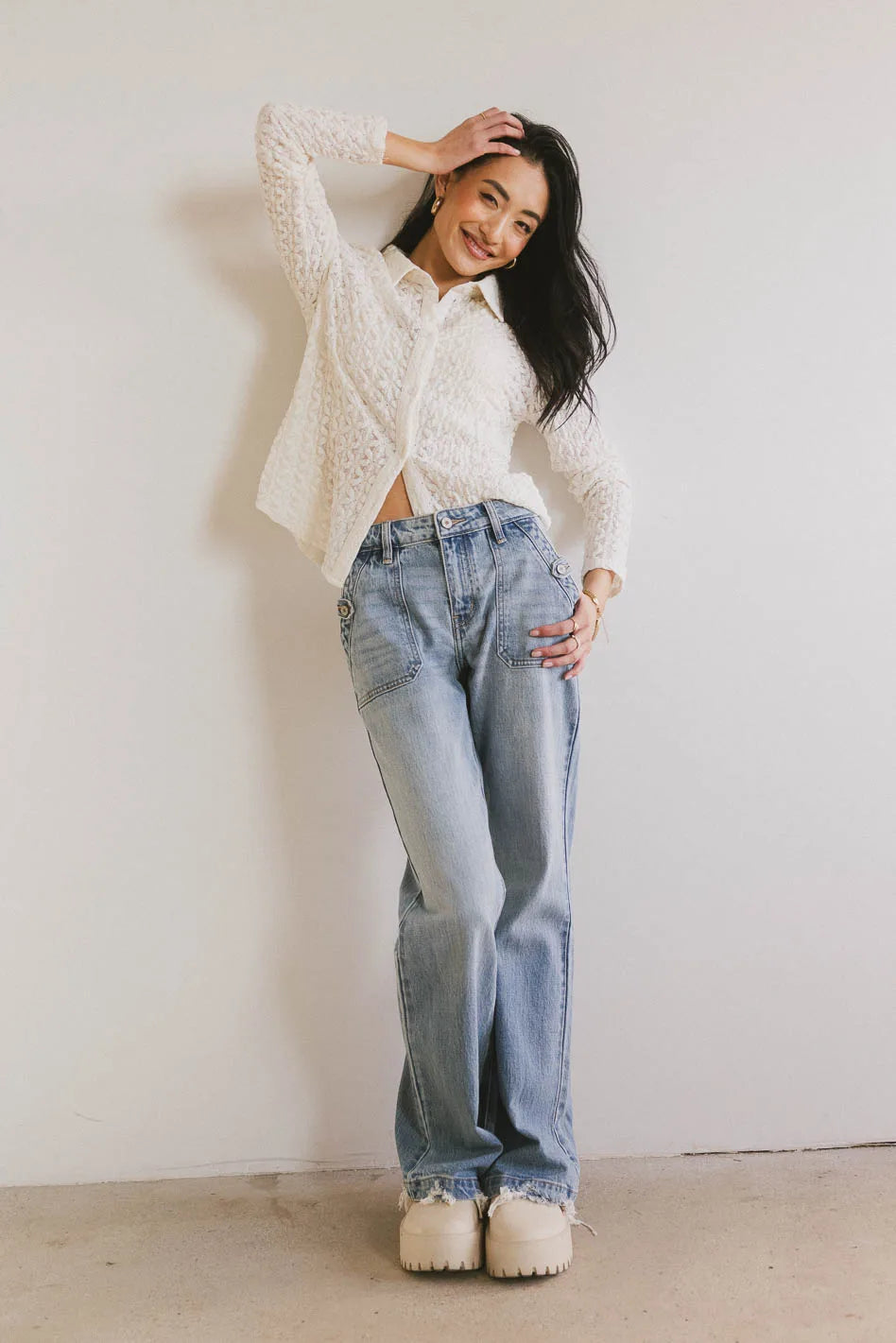 Top in cream paired with light wash denim