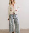 Cream cardigan paired with light denim