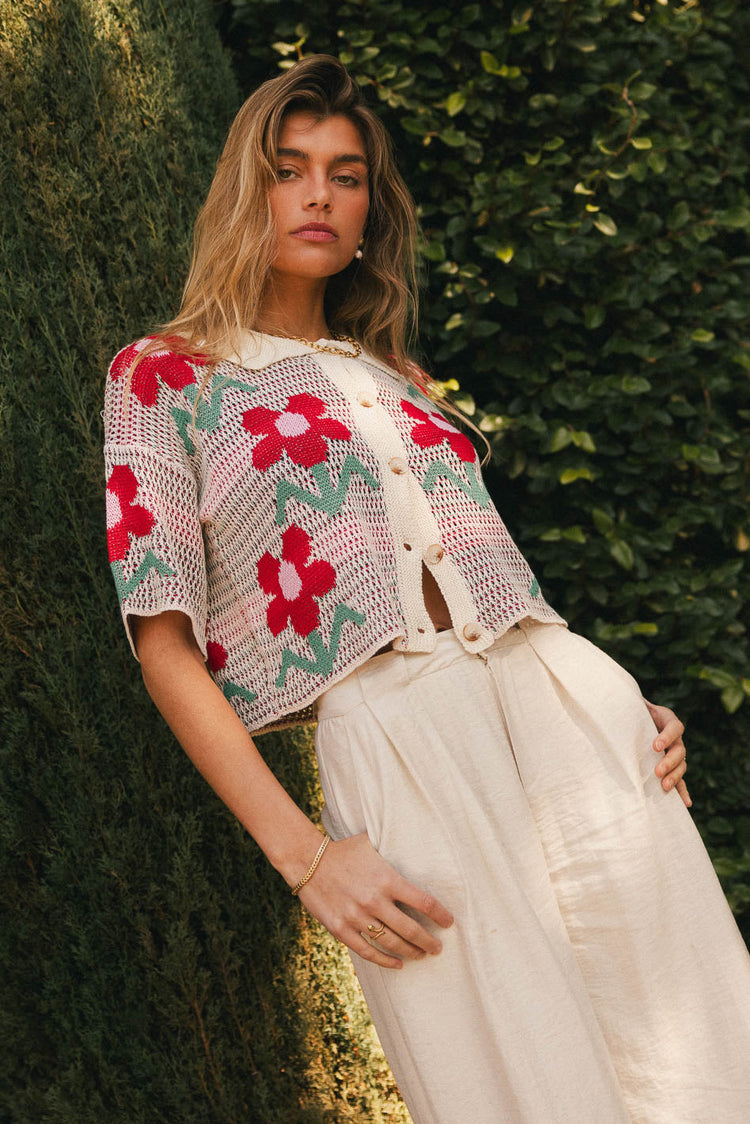 Cream top with red flowers