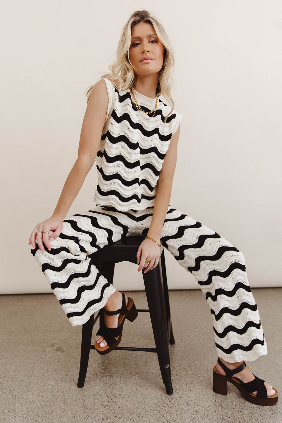 Pants in black paired with a striped black top