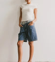 Top in ivory paired with denim shorts
