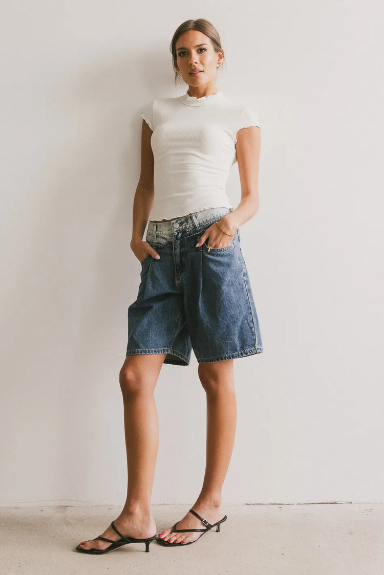Top in ivory paired with denim shorts