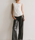 Knit top in white paired with leather pants in black