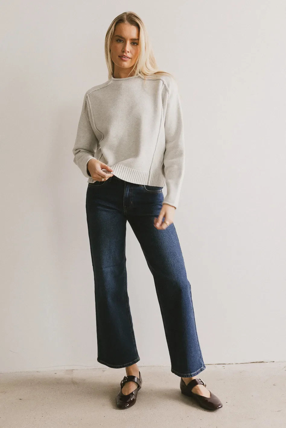 Sweater in grey paired with denim in dark wash