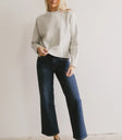 Sweater in grey paired with denim in dark wash