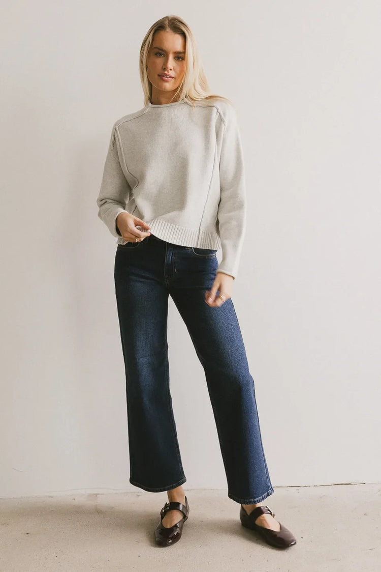 Sweater in grey paired with denim in dark wash