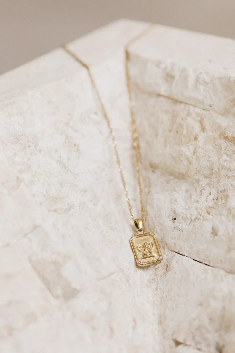 Cupid charm styled necklace in gold