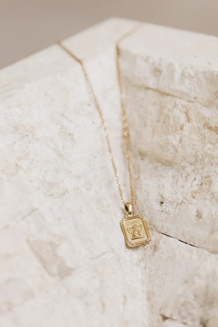 Cupid charm styled necklace in gold